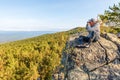 A tourist sits on top of a mountain Royalty Free Stock Photo
