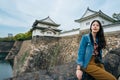 Tourist sitting outdoor in the sunny day on the big rock. female lens man joyful enjoy the beauty view of blue sky. deep river