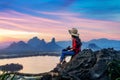 Tourist sitting on Phu sub lek viewpoint at sunset, Lopburi, Thailand