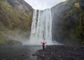 Tourist at SkÃÂ³gafoss waterfall Royalty Free Stock Photo