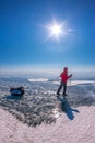 Tourist with sleds walks along the blue ice of Lake Baikal Royalty Free Stock Photo