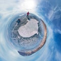 Tourist with sleds walks along the blue ice of Lake Baikal. Spherical 360 panorama little planet Royalty Free Stock Photo