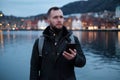 Tourist with a smartphone against Tyskebryggen in Bergen, Norway