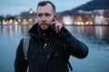 Tourist with a smartphone against Tyskebryggen in Bergen, Norway
