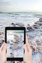 Tourist snapping photo of crystal salt on Dead Sea Royalty Free Stock Photo