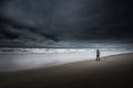 Tourist on South Jetty Beach Oregon Coast Dark Cloudy day