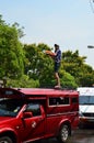 Tourist stand on bus roof for celebrating Songkran (Thai new year / water festival) in the streets