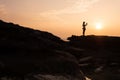 Tourist stand on rock cape and taking sunset image on tropical island. Koh Kood - Thailand