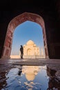 tourist standing in front entrance gate of Taj Mahal indian palace. Islam architecture. Door to the mosque