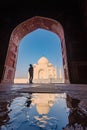 tourist standing in front entrance gate of Taj Mahal indian palace. Islam architecture. Door to the mosque