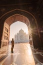 tourist standing in front entrance gate of Taj Mahal indian palace. Islam architecture. Door to the mosque Royalty Free Stock Photo