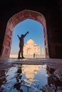 tourist standing in front entrance gate of Taj Mahal indian palace. Islam architecture. Door to the mosque