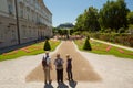 Tourist standing infront of famous Mirabell Gardens with the old