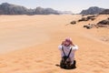 A tourist standing by the look out of a panoramic view of the desert in Wadi Rum, Jordan, Middle East