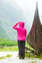 Tourist standing near old wooden viking boat in norwegian nature Royalty Free Stock Photo