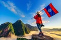 Tourist standing on Pha Dang viewpoint at sunrise in Muang Ngoy, Laos