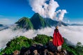 Tourist standing on Pha Dang viewpoint at sunrise in Muang Ngoy, Laos