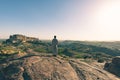 Tourist standing on rock and looking at expansive view of Jodhpur fort from above, perched on top dominating the blue town. Travel Royalty Free Stock Photo