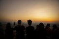 Tourist standing in sun rising site and taking a photo of sun risng sky