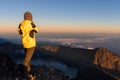 Tourist standing on top of Rinjani mountain and enjoy volcano sunrise view