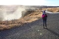 Tourist standing at Waterfall Gullfoss, Golden Circle tour, Iceland