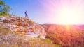 A tourist stands on top of a mountain and admires from above a view of the Ural taiga. Royalty Free Stock Photo