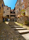 Tourist on the steps in old historic alley in the medieval village of Anghiari near city of Arezzo in Tuscany, Italy Royalty Free Stock Photo