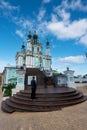 Tourist at the steps of the ornate and beautiful St. Andrew`s church in Kiev, Ukraine Royalty Free Stock Photo