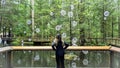 Tourist stops to admire one of the artful displays at the Capilano Suspension Bridge attraction site in North Vancouver, BC.