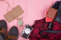 Tourist stuff - bag, passport, camera, compass, shoes, shirt, note pad and blank blackboard on wooden background