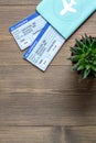 Tourist stuff with passport and tickets on wooden background top view mockup