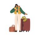 Tourist with suitcase, travel bag, waiting for flight departure, checking time with watch. Happy woman passenger with