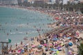 Tourist sunbathe or bath on the sea in crowded El Arenal beach in Mallorca Royalty Free Stock Photo