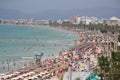 Tourist sunbathe or bath on the sea in crowded El Arenal beach in Mallorca wide Royalty Free Stock Photo