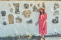 Tourist surprised by finds on the wall in Carthage. Exhibits archaeological excavations in wall Carthage. Statues and parts of