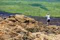Tourist take a photo of the hot volcanic lava from Piton de la Fournaise volcano in Sainte-Rose De La Reunion, France.