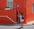 Tourist takes photo of colourful house in the Malay Quarter, Bo Kaap, Cape Town, South Africa. Historical area of painted houses.