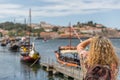 A tourist takes a photo of the famous rabelos boats in the city of Oporto. The rabelo boat is a Portuguese boat, typical of the Royalty Free Stock Photo