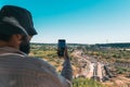 A tourist takes a photo with his phone of the ancient city of Perge from above. Royalty Free Stock Photo