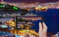 Tourist takes photo of night city Bodrum by tablet pc