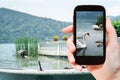 Tourist takes picture of swans in lake, Bavaria