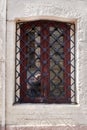 A tourist takes a picture of a vintage window