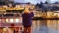 A tourist takes pictures of sights with his mobile phone