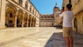 a tourist takes pictures, street view of the old town Dubrovnik, Croatia, medieval European architecture, the concept of traveling