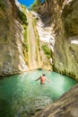 Tourist taking a bath inside Nidri Waterfall in Lefkada Greece