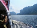 A tourist taking a photo of the breathtaking views of the Western Brook Pond