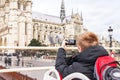 Tourist taking photo on cathedral of Notre Dame de Paris. Royalty Free Stock Photo