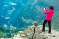 Tourist taking photo from Dalsnibba viewpoint Norway Royalty Free Stock Photo