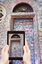 Tourist taking photo of door of Juliet House