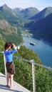 Tourist taking photo of fjord landscape, Norway Royalty Free Stock Photo